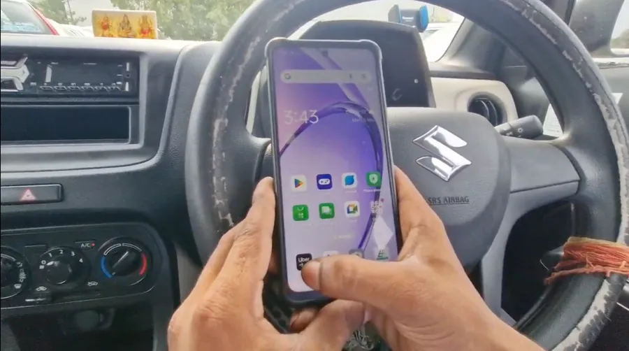 Driver making a payment on a phone inside a car